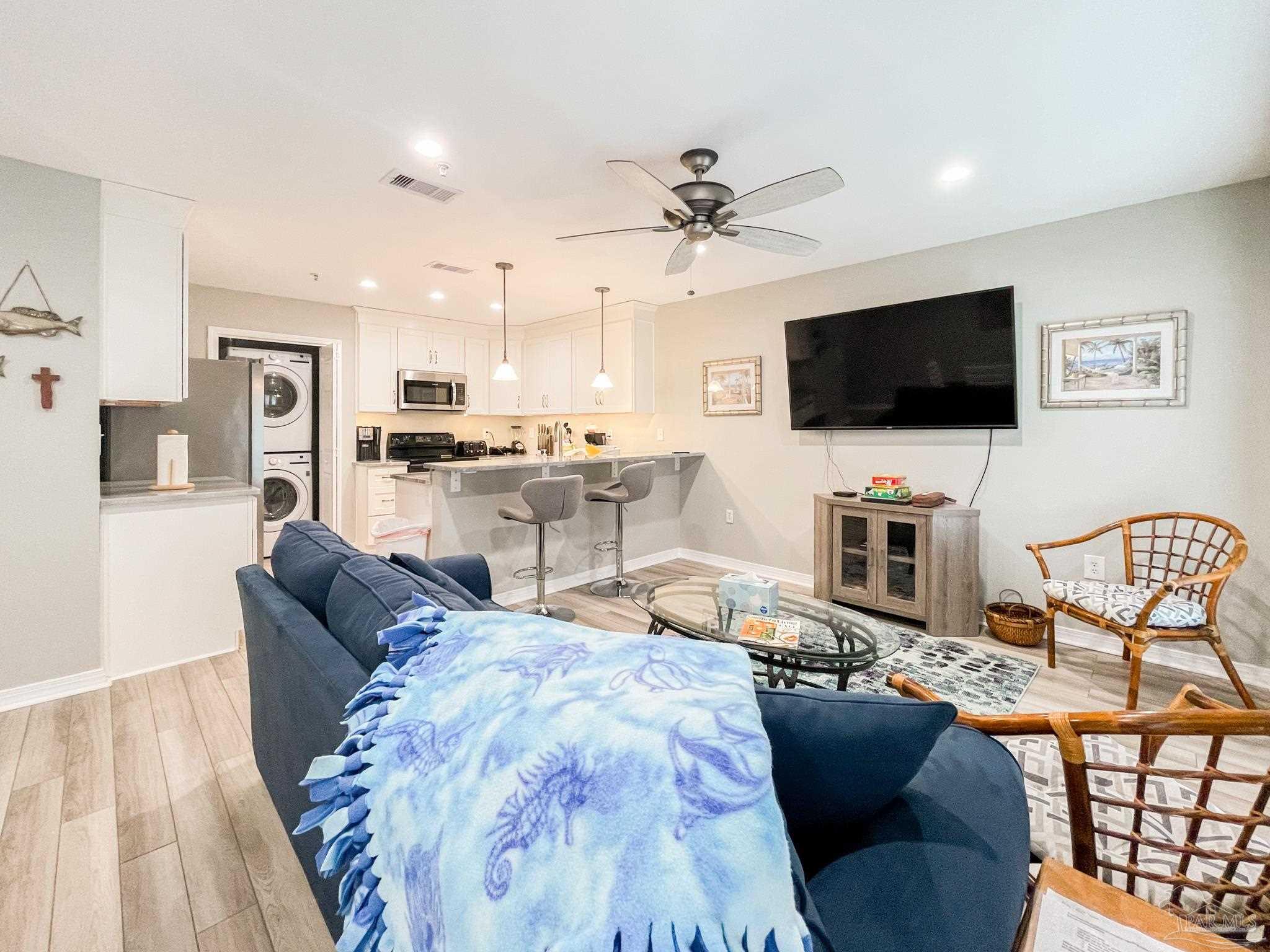 13351 Johnson Beach Road, Unit 402E Pensacola, FL 32507 - Photo 20 of 30 a living room with furniture and a flat screen tv