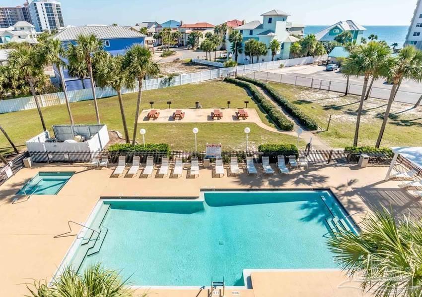 13351 Johnson Beach Road, Unit 402E Pensacola, FL 32507 - Photo 3 of 30 a view of a swimming pool with a patio