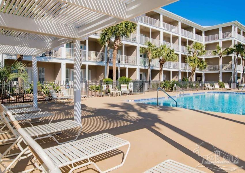 13351 Johnson Beach Road, Unit 402E Pensacola, FL 32507 - Photo 6 of 30 a view of a building with garden