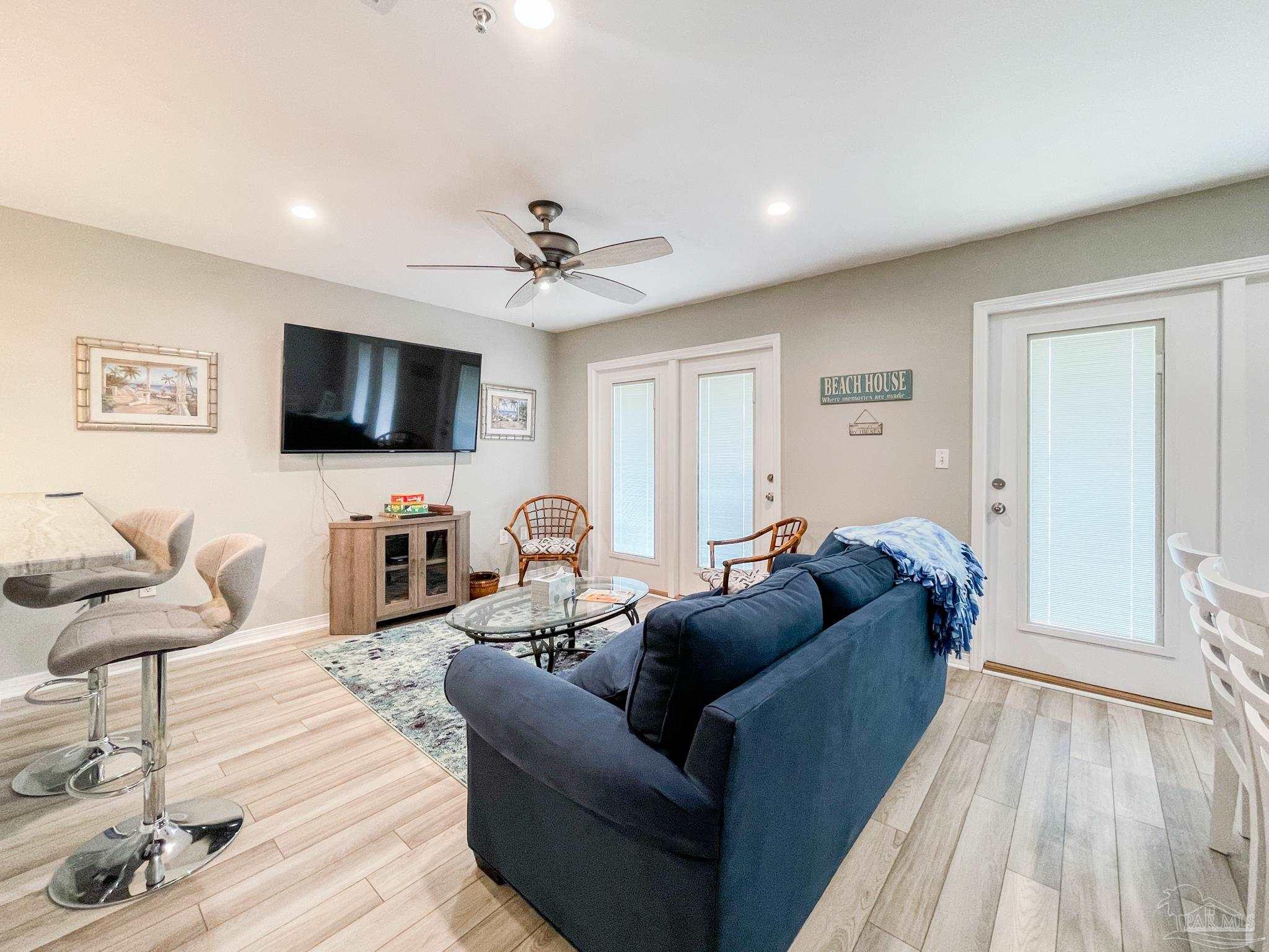 13351 Johnson Beach Road, Unit 402E Pensacola, FL 32507 - Photo 9 of 30 a living room with furniture and a flat screen tv