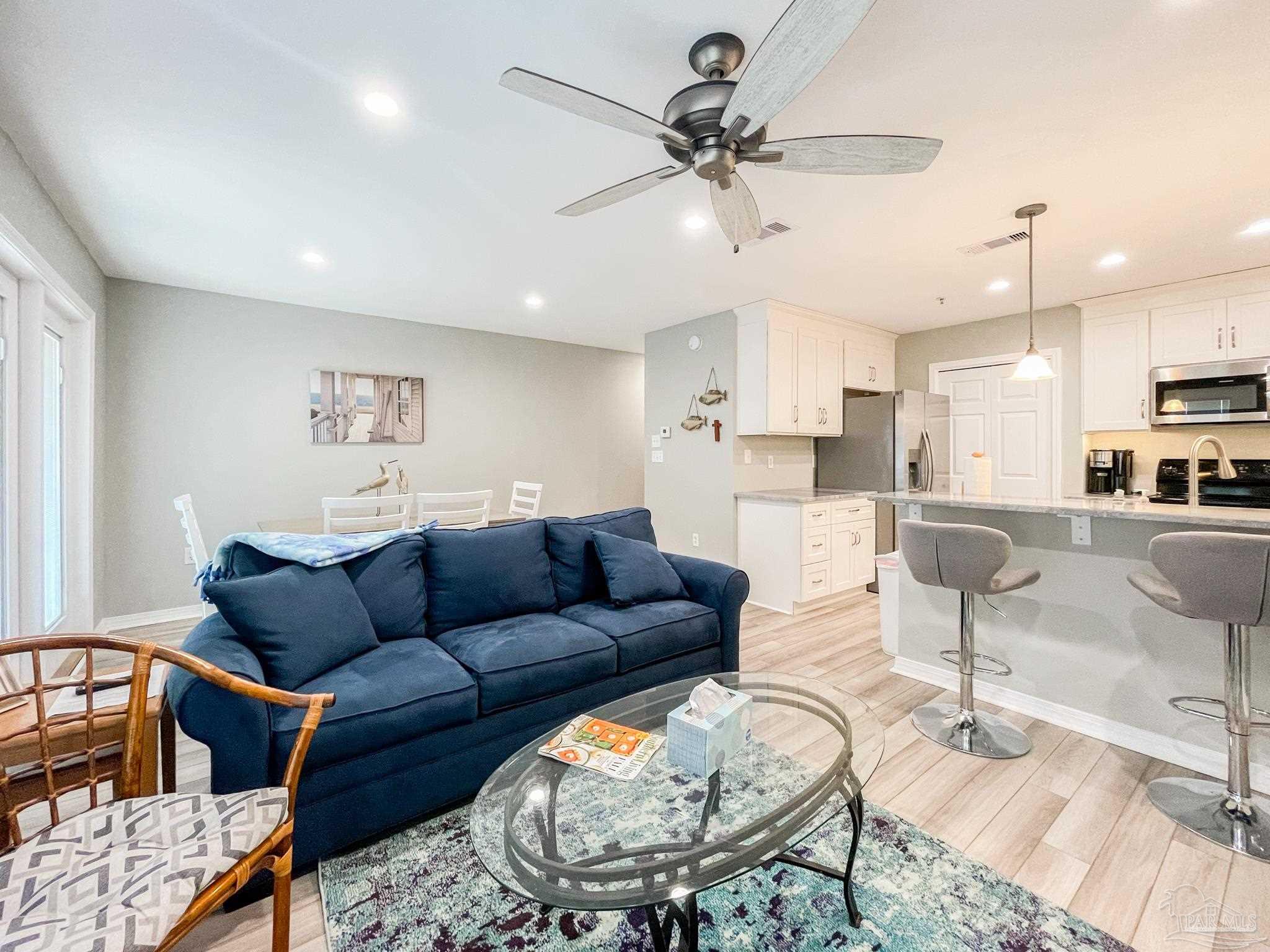 13351 Johnson Beach Road, Unit 402E Pensacola, FL 32507 - Photo 10 of 30 a living room with furniture and a view of kitchen