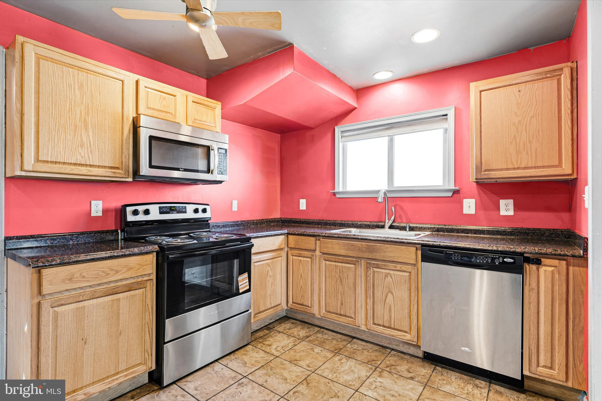 6156 Ripley Road La Plata, MD 20646 - Photo 15 of 26 a kitchen with granite countertop a stove microwave cabinets and sink