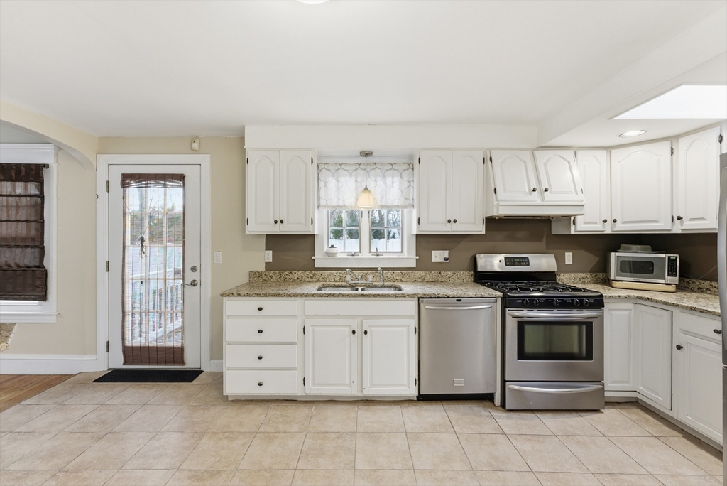36 Garland Street Springfield, MA 01118 - Photo 12 of 42 a kitchen with stainless steel appliances granite countertop a stove and a refrigerator