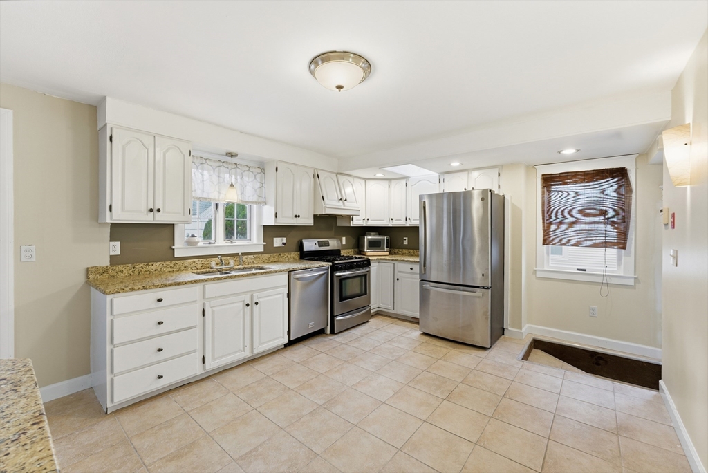 36 Garland Street Springfield, MA 01118 - Photo 13 of 42 a kitchen with granite countertop a refrigerator and a stove top oven