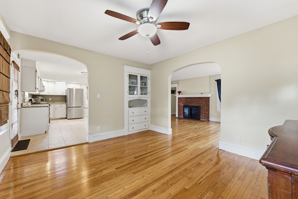 36 Garland Street Springfield, MA 01118 - Photo 20 of 42 a view of a livingroom with wooden floor a ceiling fan and kitchen view