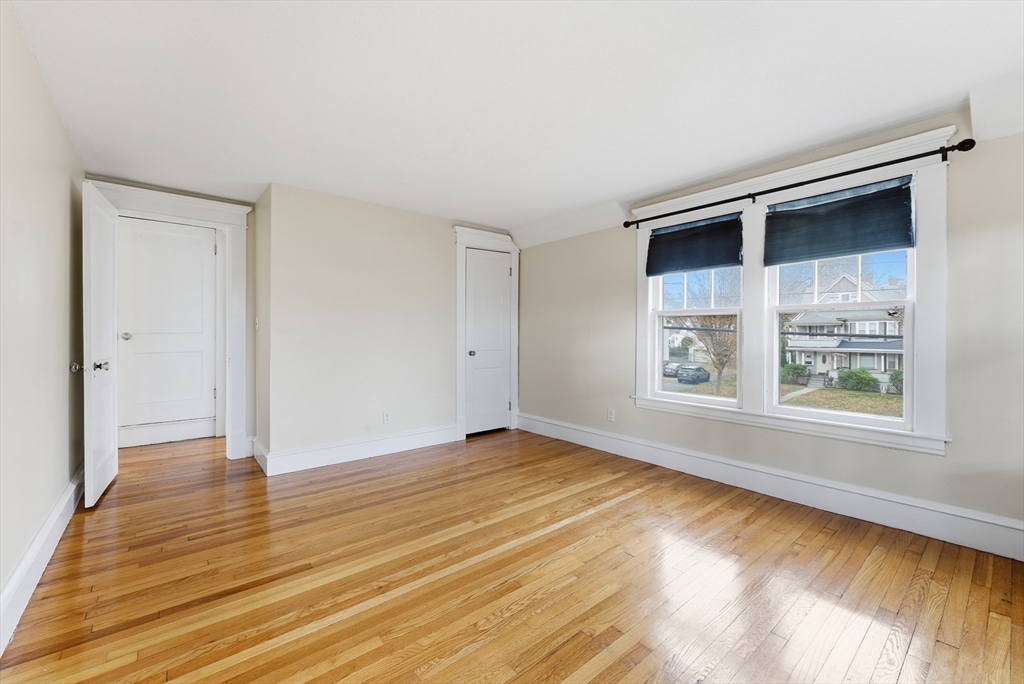 36 Garland Street Springfield, MA 01118 - Photo 25 of 42 an empty room with wooden floor and windows
