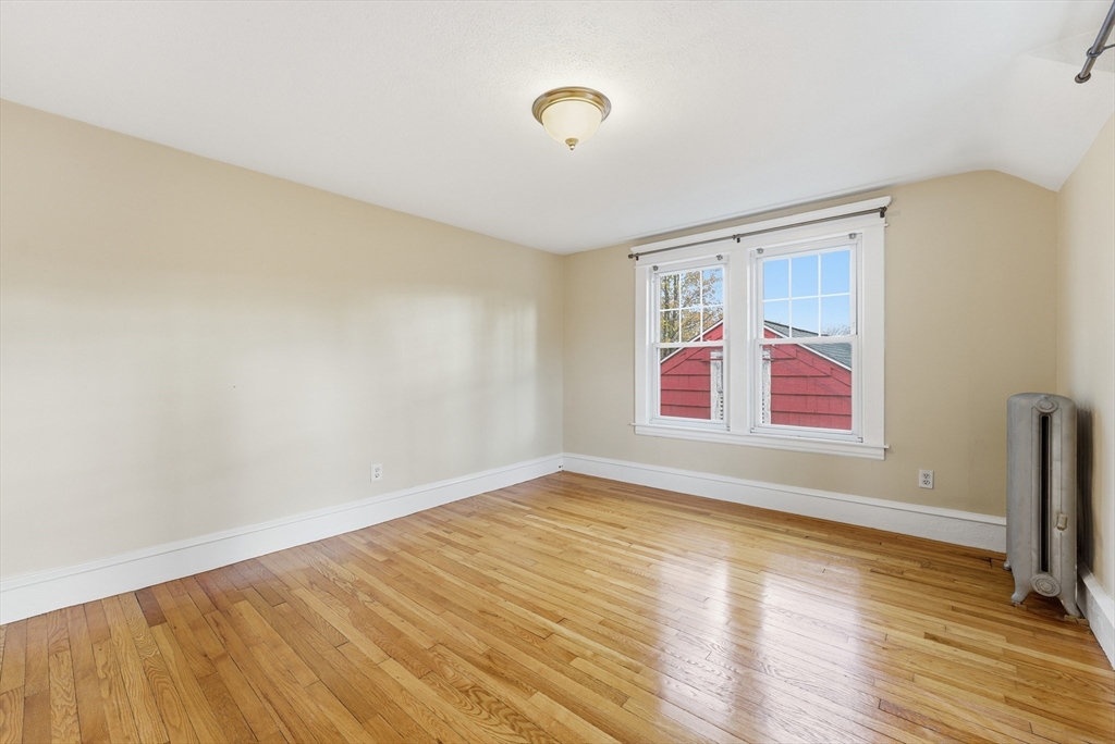 36 Garland Street Springfield, MA 01118 - Photo 33 of 42 a view of an empty room with wooden floor and a window