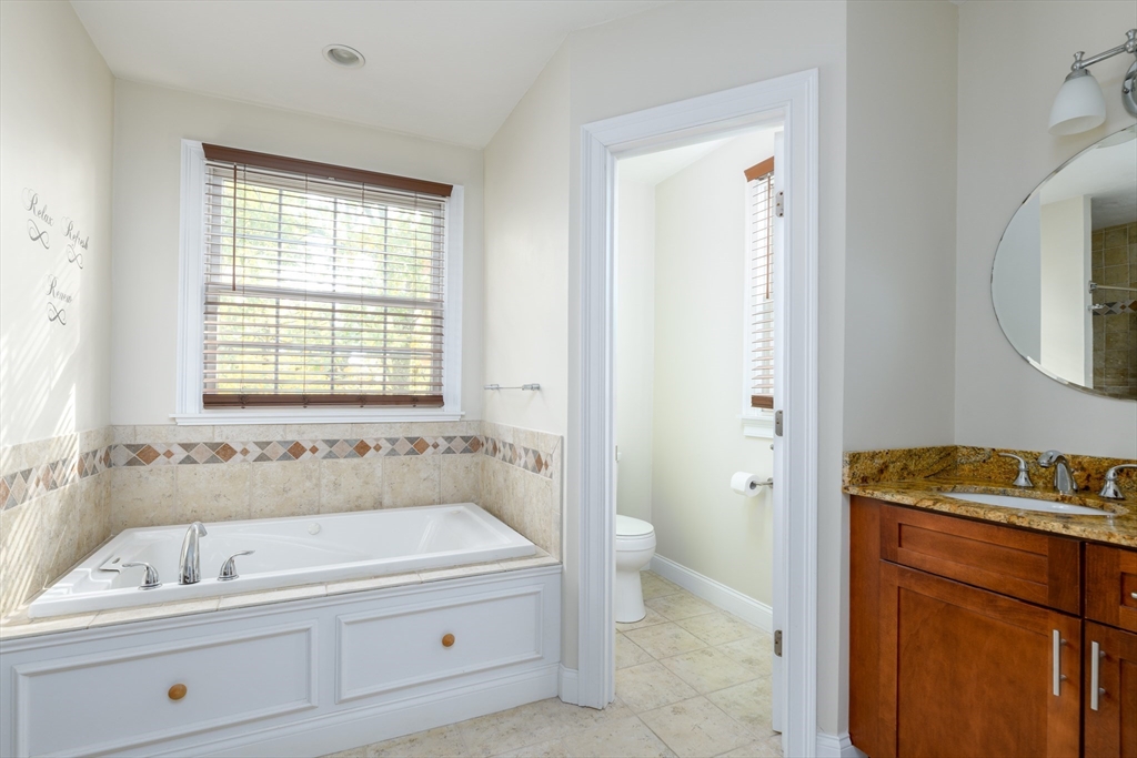 40 Rustic Drive Worcester, MA 01609 - Photo 19 of 37 a spacious bathroom with a tub sink and mirror