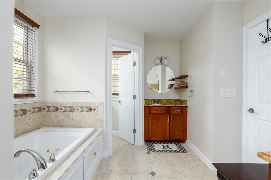 40 Rustic Drive Worcester, MA 01609 - Photo 20 of 37 a bathroom with a tub sink and mirror