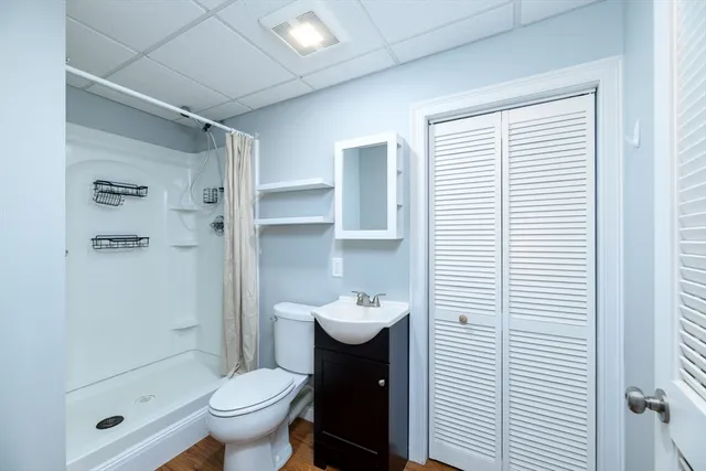 a backyard of a house with table and chairs under an umbrella