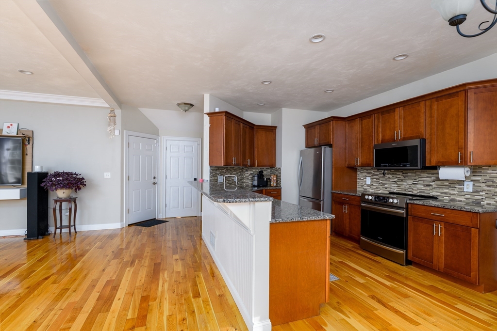 40 Rustic Drive Worcester, MA 01609 - Photo 3 of 37 a kitchen with stainless steel appliances granite countertop a stove refrigerator and a microwave