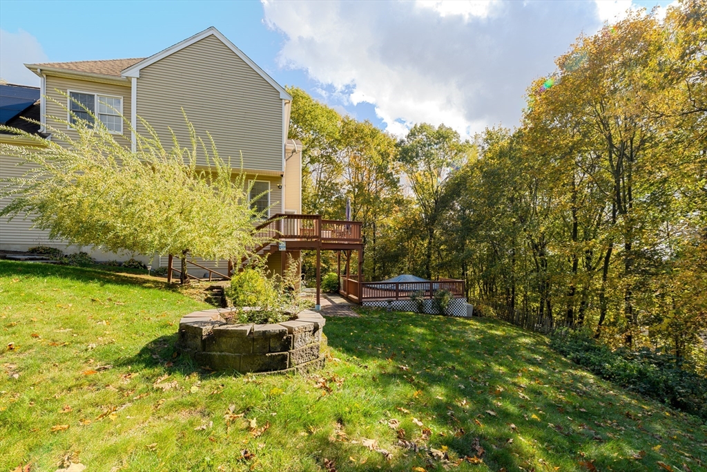 40 Rustic Drive Worcester, MA 01609 - Photo 32 of 37 a backyard of a house with table and chairs