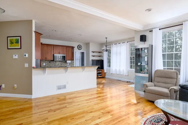 a living room with furniture and a kitchen