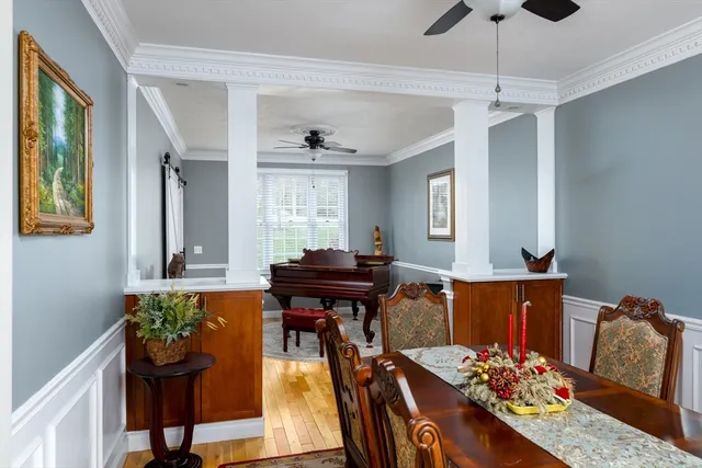 a living room with furniture a chandelier and a flat screen tv
