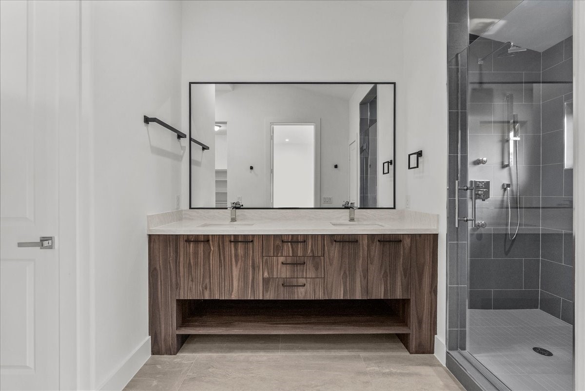 7627 Scott Avenue Manvel, TX 77578 - Photo 34 of 50 The guest suite bathroom offers a stunning dual-vanity setup, large shower, and huge walk in closet.
