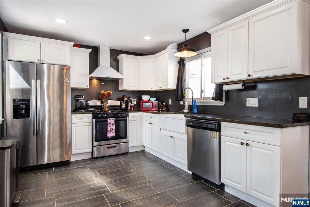405 Washington Street Boonton, NJ 07005 - Photo 9 of 24 a kitchen with granite countertop a refrigerator stove top oven and sink