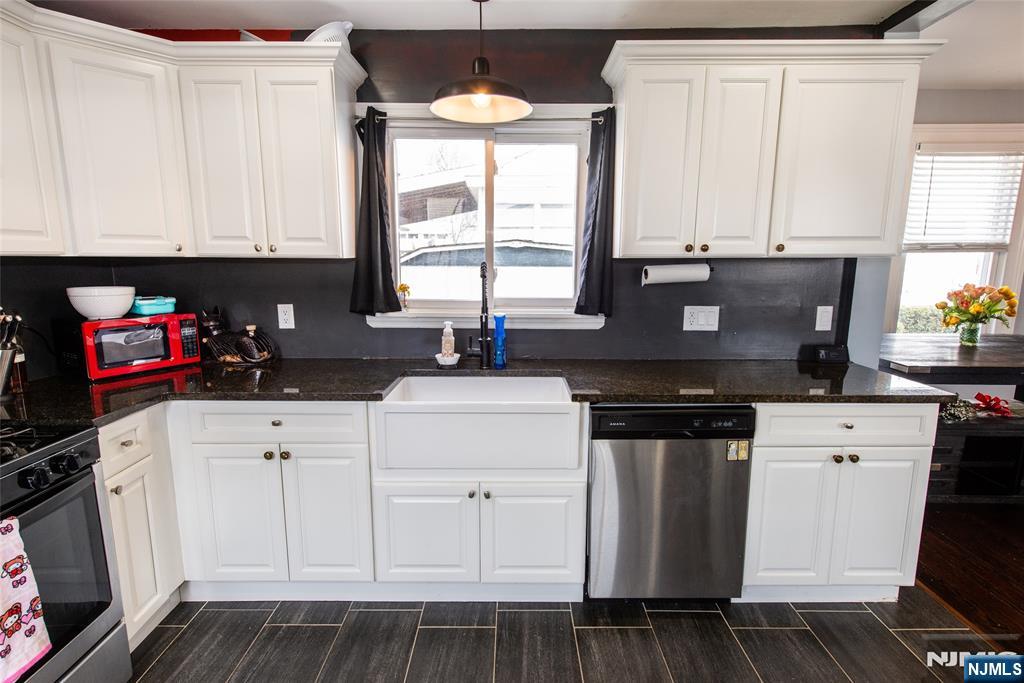405 Washington Street Boonton, NJ 07005 - Photo 10 of 24 a kitchen with granite countertop white cabinets and black appliances