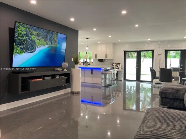 a lobby with furniture and a flat screen tv
