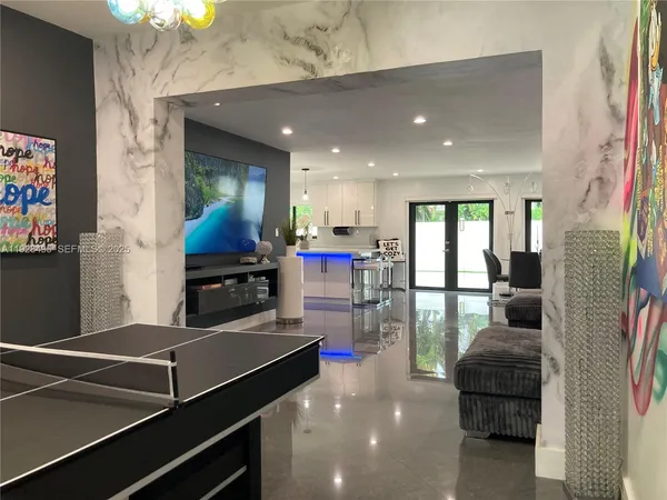 a kitchen with a refrigerator and a dining table