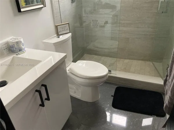 a bathroom with a window and a shower