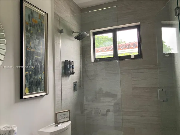 a bedroom with a bed dresser and a window