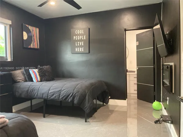 a bed room with two bed and a large mirror