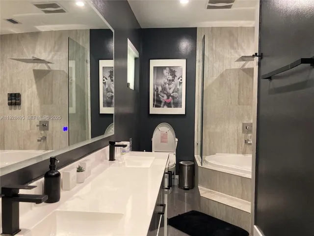 a bathroom with a tub and shower