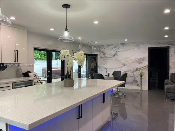 a large kitchen with a large counter top appliances and cabinets