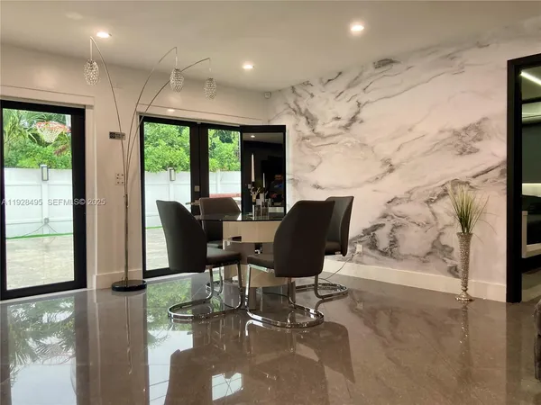 a view of a dining room with furniture a livingroom and chandelier