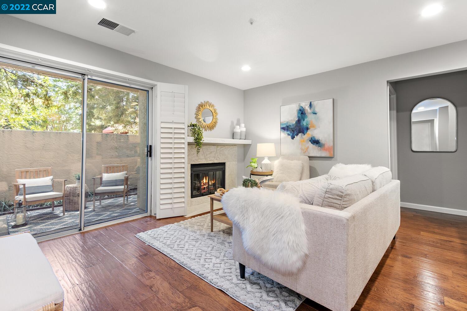 1308 Walden Road, Unit 20 Walnut Creek, CA 94597 - Photo 1 of 1 a living room with furniture and a fireplace