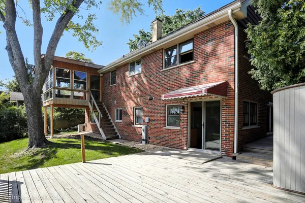 a view of a house with backyard and wooden fence