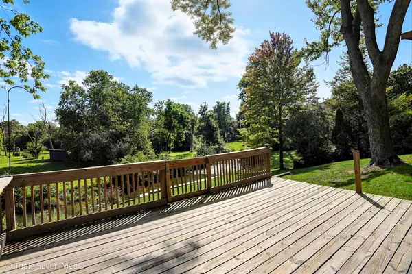 a view of wooden deck and a garden