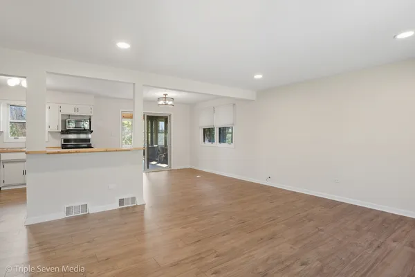 a view of a kitchen with an empty space and a window