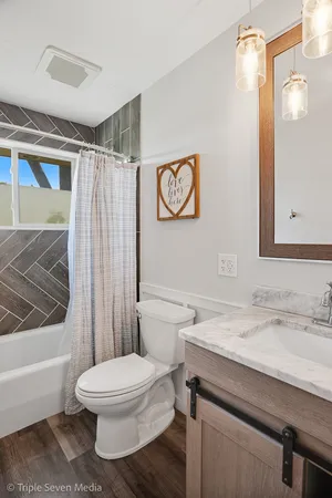 a bathroom with a toilet a sink and shower