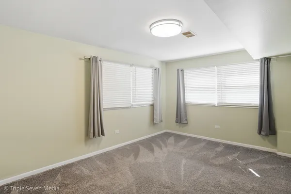 a view of an empty room and a window