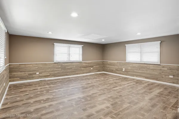 a view of an empty room with stairs and ventilation