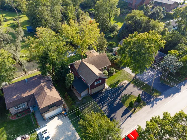 an aerial view of a house with a yard