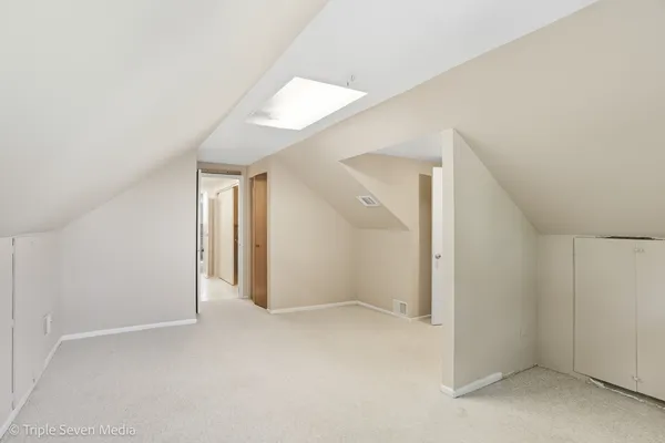 a view of a hallway with wooden floor and stairs