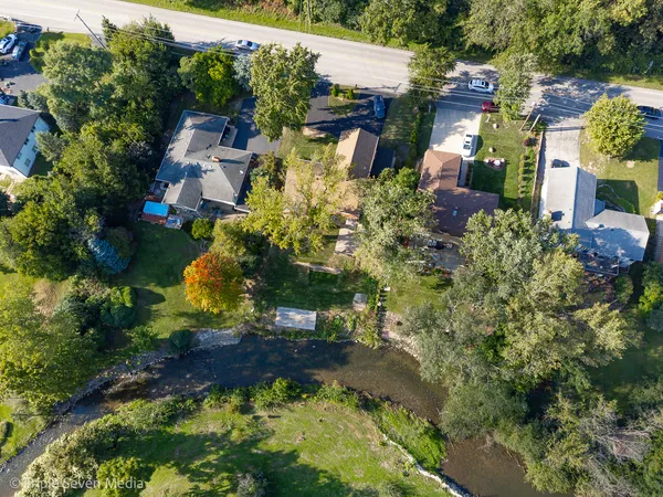 an aerial view of a house with a yard and garden