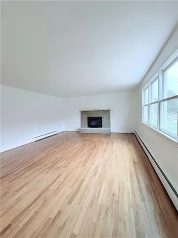 a spacious bathroom with a granite countertop sink a toilet and a large mirror