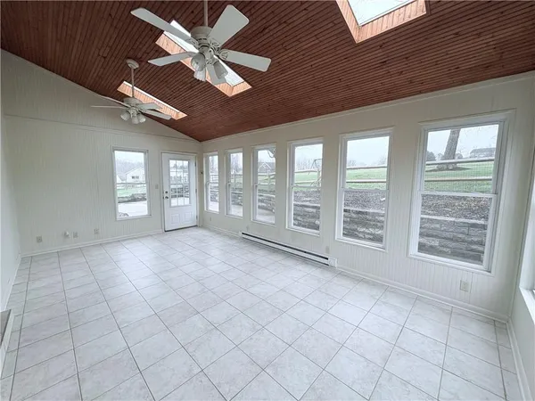 a view of kitchen and empty room with furniture
