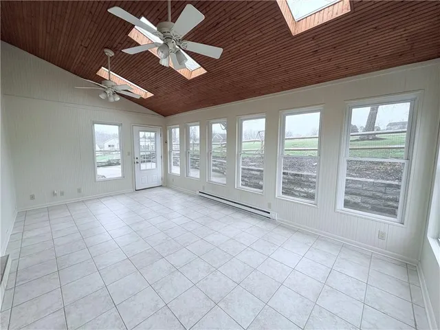 a view of kitchen and empty room with furniture