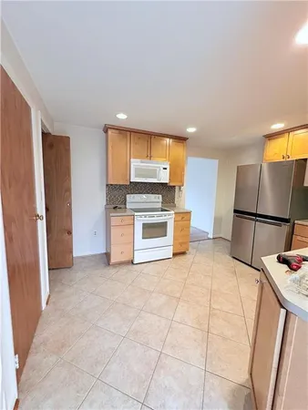 a kitchen with stainless steel appliances a refrigerator and a stove