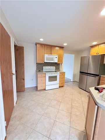 a kitchen with stainless steel appliances a refrigerator and a stove