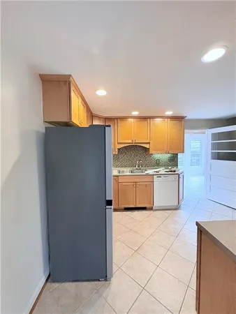 a kitchen with stainless steel appliances granite countertop a sink and a refrigerator