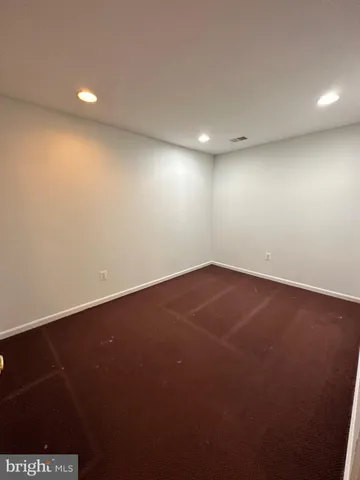 an empty room with a hard wood floor and a window