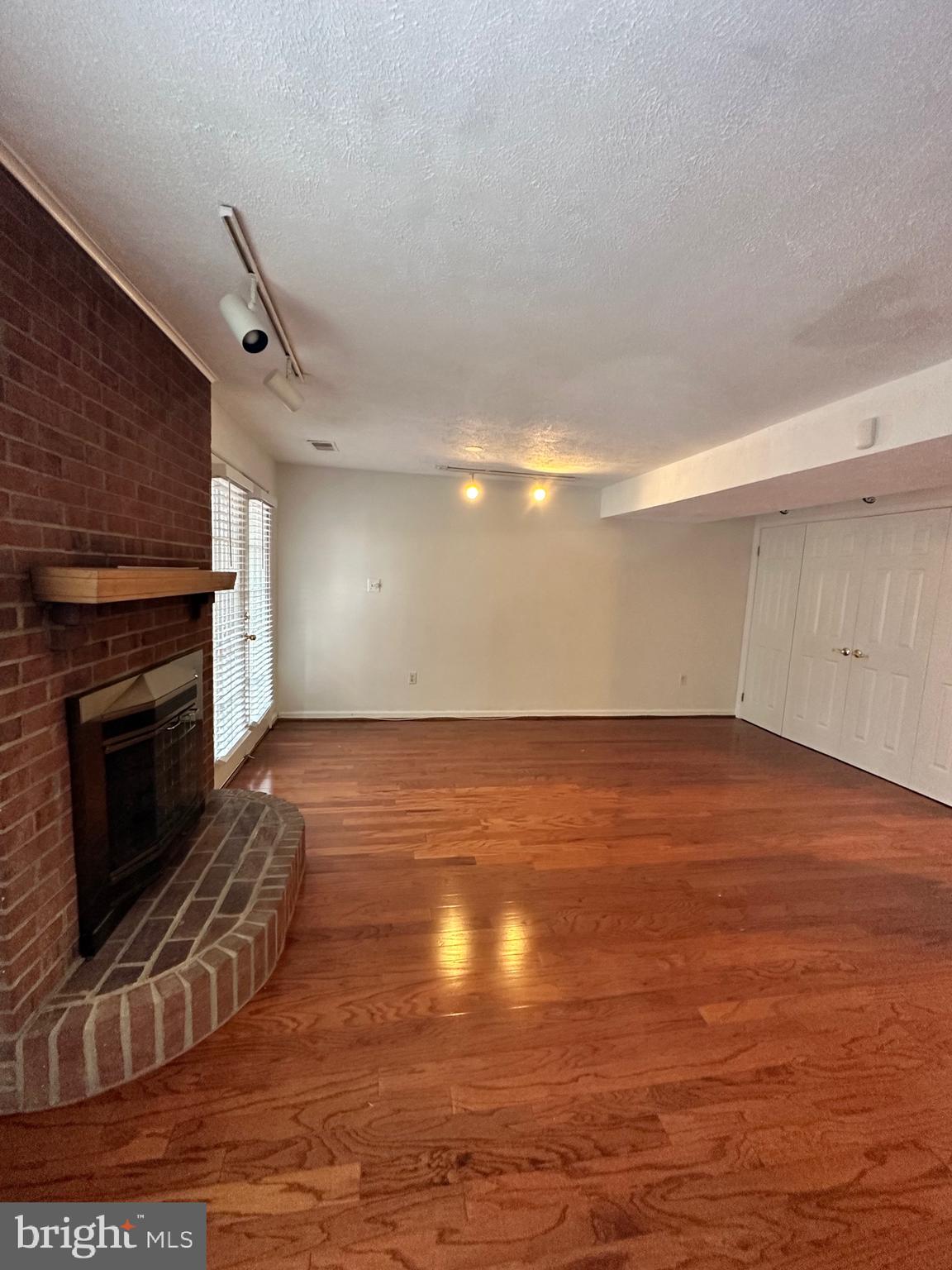 2258 Cartbridge Road Falls Church, VA 22043 - Photo 23 of 35 a view of empty room with wooden floor and fireplace