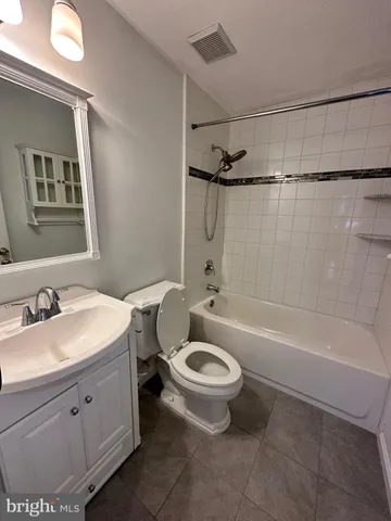 a bathroom with a sink a toilet and a bathtub