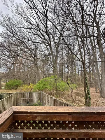 a view of deck with furniture and wooden fence
