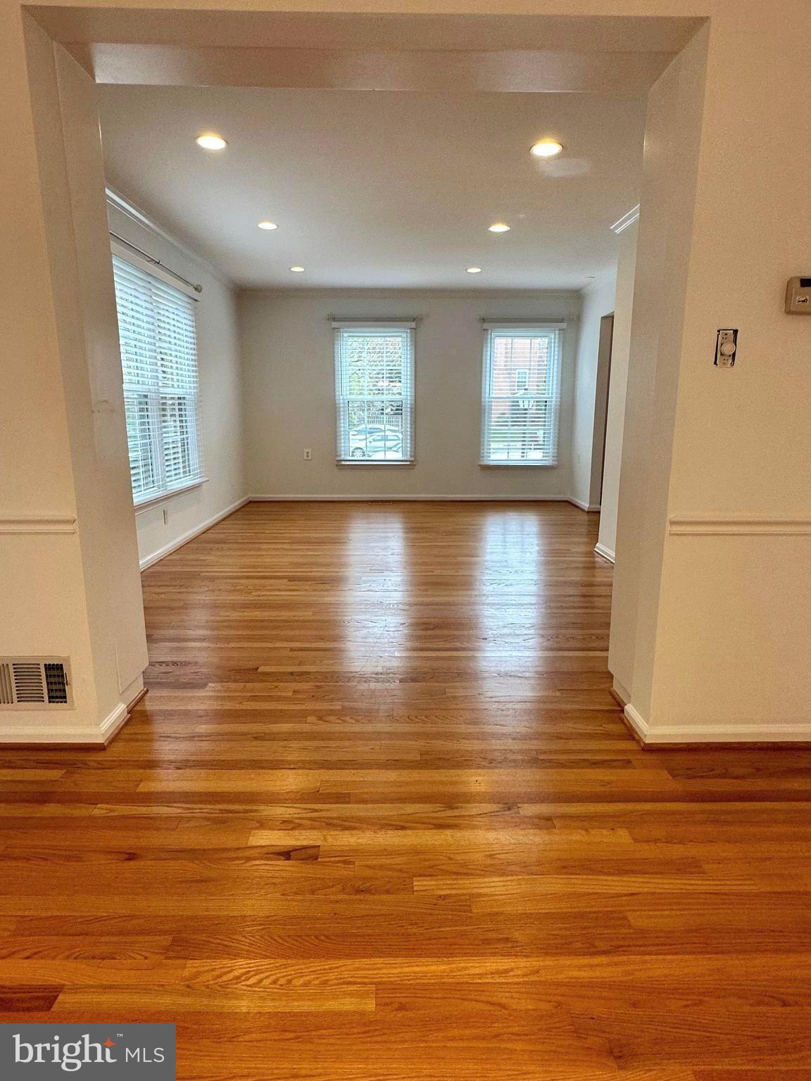 2258 Cartbridge Road Falls Church, VA 22043 - Photo 4 of 35 a view of an empty room with wooden floor and a window